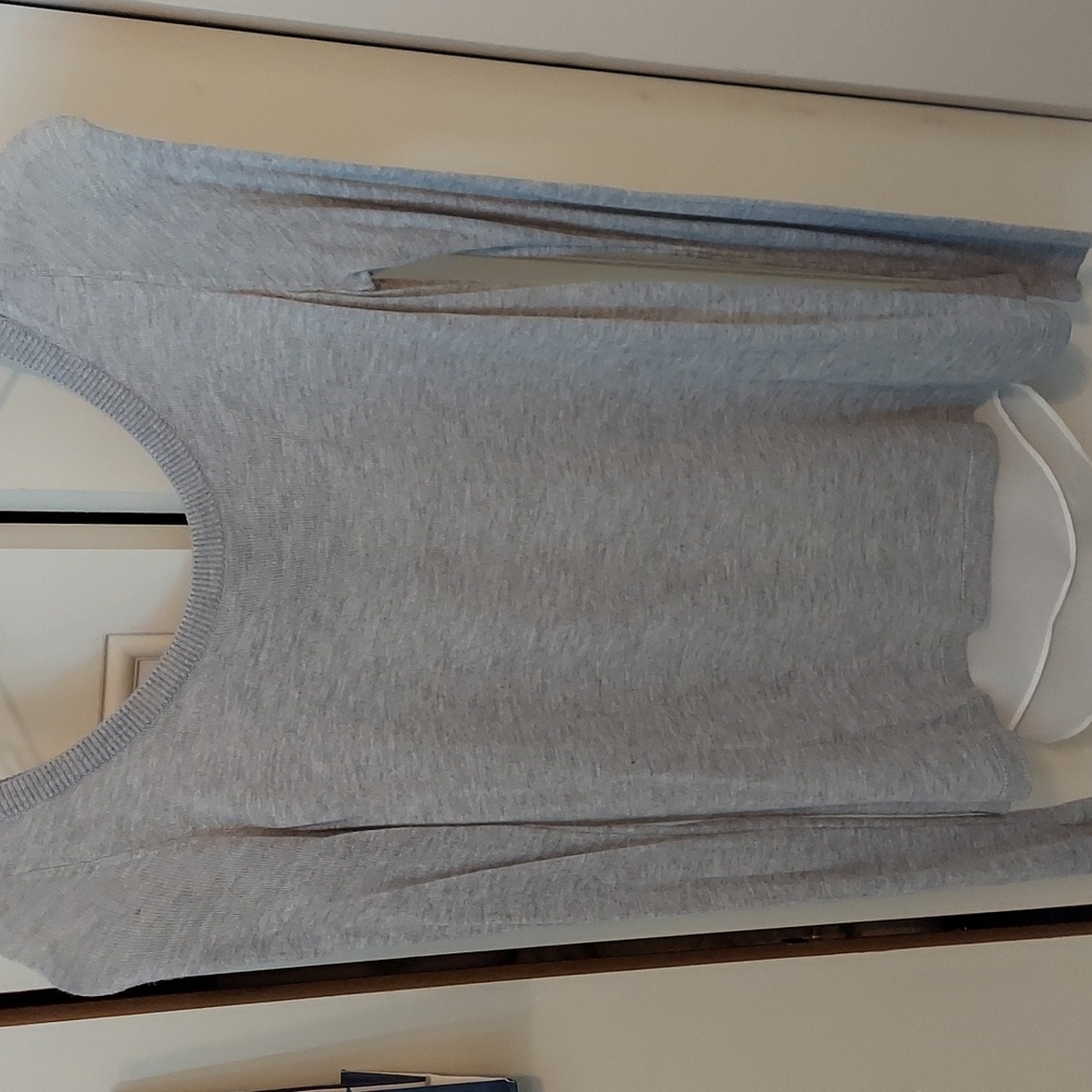 Small gray sweater with back cut revealing white sheer tank top attached